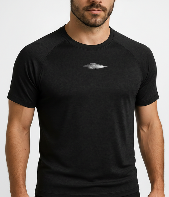 Man wearing a black t-shirt with a logo on a plain background