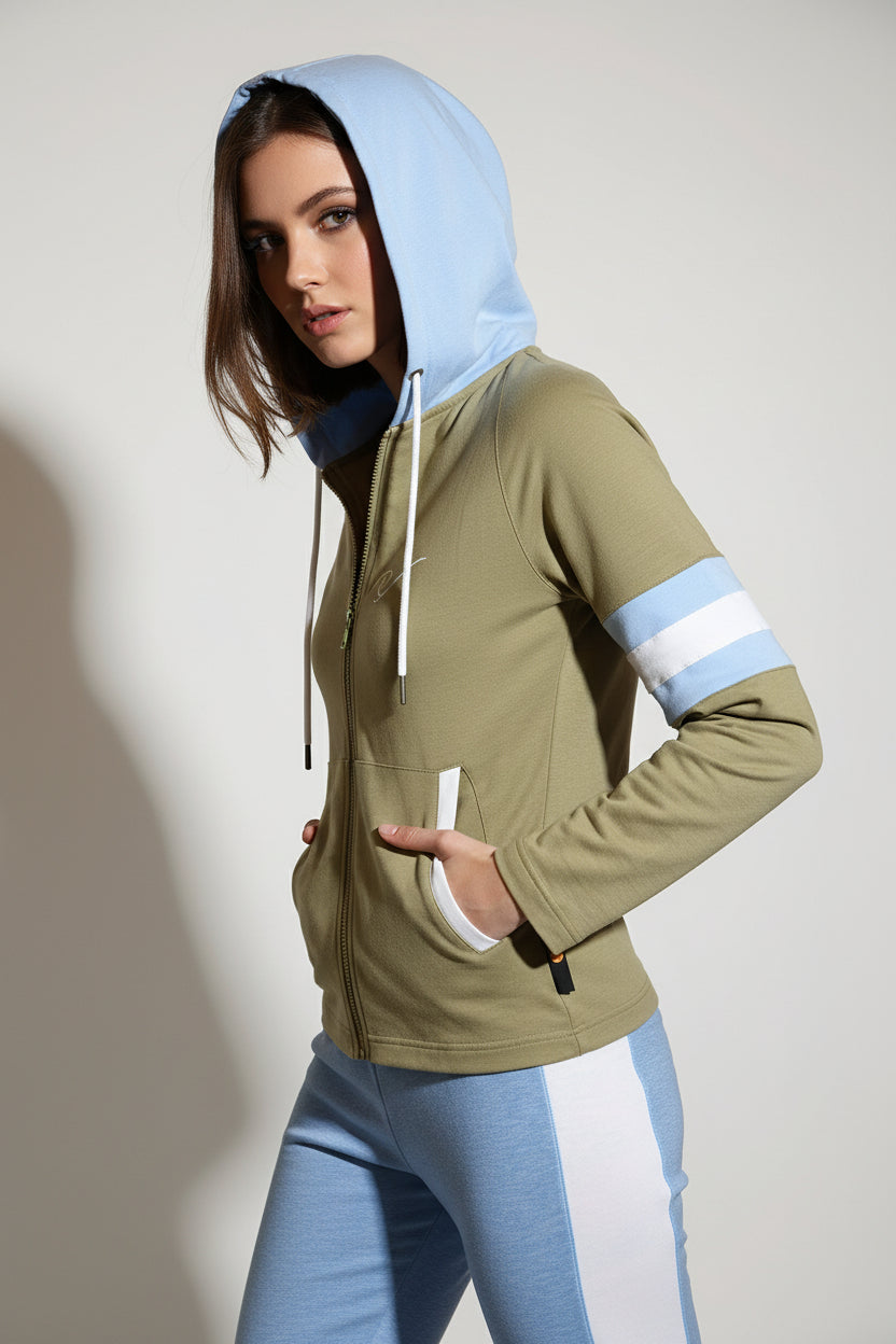 Mannequin wearing a green jacket with reflective stripes against a dark wooden background